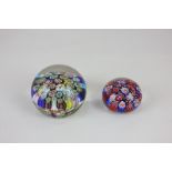 An Italian glass millefiori paperweight and a smaller millefiori paperweight