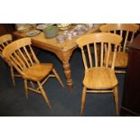 A set of four light wood dining chairs with slatted backs and solid seats, on turned legs and