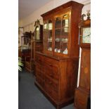 A Victorian flame mahogany secretaire bookcase with two panel glazed doors enclosing two shelves, on