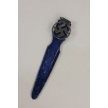 A white metal mounted blue plastic page marker marked Sterling, with pierced swastika design