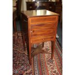 An Edwardian inlaid mahogany cupboard with panelled door and drawers beneath, on square chamfered