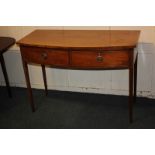 An Edwardian mahogany and satinwood strung bow front side table with two drawers, on slender