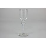 A cordial glass with white twist knopped stem, rough pontil mark to base