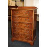 An inlaid yew wood chest of five drawers with brass drop handles, on bracket feet, 67cm