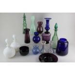 A collection of coloured glass vases and decanters to include a pale green glass vase with a snake