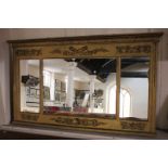 A gilt painted three-section rectangular wall mirror, cornice and frieze with relief of trophies and