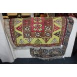 A Persian style wool rug, red and brown rectangular geometric centre on yellow field, 143cm by 94cm,