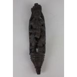A carved wooden figure playing a pipe, 30cm long