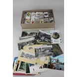 A small collection of black and white and colour postcards, including photographic views, together
