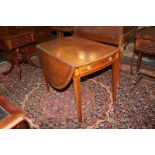 An Edwardian inlaid mahogany Pembroke table with oval drop-leaf top, end drawer, on square tapered