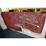 A Bokhara rug with four central elephant foot motifs, on crimson field, 154cm by 92cm, a similar