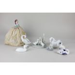 A Lladro porcelain model of a goose, 11cm, together with a Nao model of three geese, 12cm, a