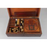 A Victorian games compendium in walnut box, containing solitaire board with marbles, dominoes,