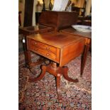A Victorian mahogany drop-flat side table with two drawers and opposing dummy drawers, on turned