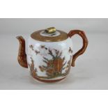 A Japanese Kutani porcelain teapot, decorated in rust and gilt with birds amongst a garden, and a