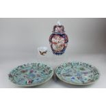 Two similar Chinese porcelain plates decorated with figures, flora and fauna, on celadon ground,