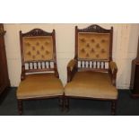 A pair of Victorian fireside king and queen chairs with foliate and shield carved surmount and