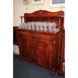 A Victorian mahogany chiffonier, the raised back with scroll carved surmount and shelf on turned
