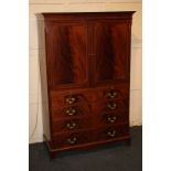 A George III style mahogany cocktail cabinet with flame veneered cupboards enclosing cut-out shelf