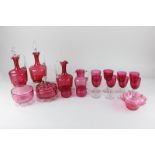 A collection of Victorian cranberry glass including two jugs with stoppers, eight wine glasses,