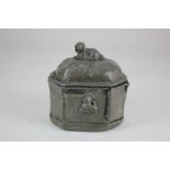 A 19th century lead tobacco box and cover, of octagonal form with spaniel shaped finial, 14.5cm