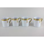 A set of four Frank Lloyd Wright for Tiffany & Co coffee mugs with geometric gilt decoration on