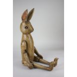 A painted wooden figure of a rabbit with jointed limbs, 69cm