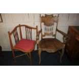 A Continental carved carver dining chair with shaped and spindled back, scroll arms and solid