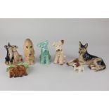 Four Sylvac pottery models of dogs, a Beswick ashtray modelled with three puppies, a John Beswick