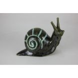 A pottery money bank in the form of a snail, in green glaze, 18cm