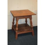 An oak side table with square top on baluster turned supports with undershelf, on block feet, 60cm