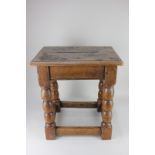 An oak jointed stool with turned legs