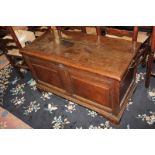 A 17th century oak coffer with moulded two-panel front containing candle box, on bracket feet,