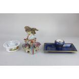 An unusual Continental porcelain inkwell modelled as an eagle sitting on a globe, with three