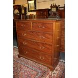 A mahogany chest of two short over three long drawers with brass swan neck drop handles, on