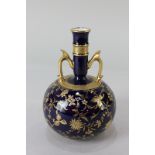 A Mintons porcelain globular bottleneck vase with gilded floral pattern on blue ground, the base