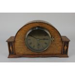 A 20th century light oak cased mantel clock, the brass dial marked Harrods Ltd, London, 29cm