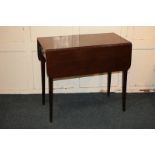 A mahogany Pembroke table with two drop flaps, drawer and opposing dummy drawer with brass knob