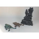 A Punch and Judy cast iron door stop, 34cm, (a/f), together with two boot pulls in the form of