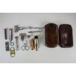A collection of smoker's tools and accessories, to include a gold mounted cigarette holder in silver