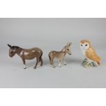 A Beswick model of an owl (2026), a donkey (1364B) and a donkey foal (2110)