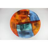 A Poole Pottery charger with abstract decoration in shades of blue and orange, 40cm