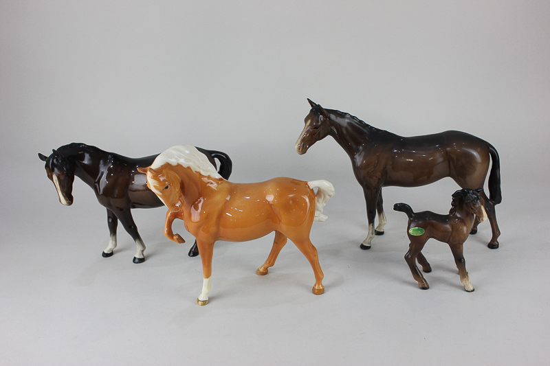 Four Beswick porcelain models of horses, head tucked with leg up (1549) in chestnut gloss, a mare (