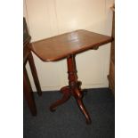 A 19th century mahogany tilt top table, with rectangular shaped top on turned stem and outswept
