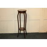 An Edwardian inlaid mahogany jardiniere stand with circular top on four curved legs with platform