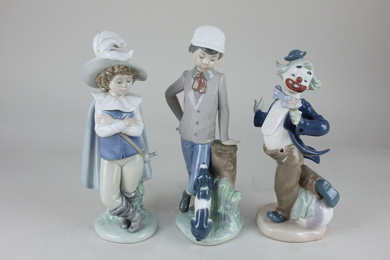 Three Nao figures comprising a clown holding a flower, 21cm, a musketeer, 24.5cm, and a boy with a