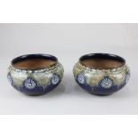 A pair of Royal Doulton vases of baluster form with tubeline floral decoration on blue and green