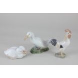 Three Royal Copenhagen porcelain models of birds, comprising a white duck, 9.5cm, two ducklings,