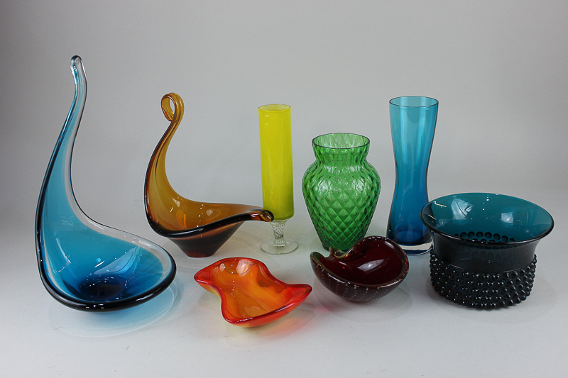 A collection of coloured glass vases, bowls and dishes, to include a blue dish with elongated