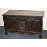 A late 17th century carved oak coffer with three-panel front, the central carved with vase and